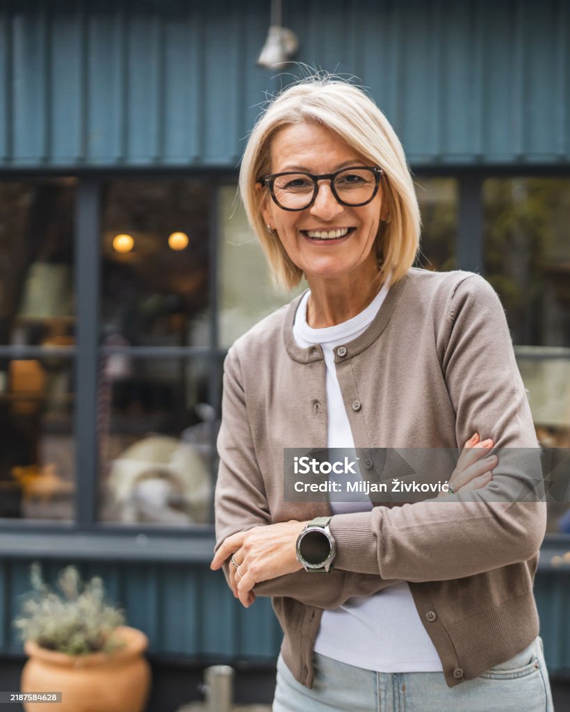 portrait of woman entrepreneur stand arm crossed in front restaurant
